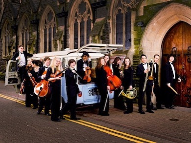 An image of young musicians getting out of a van
